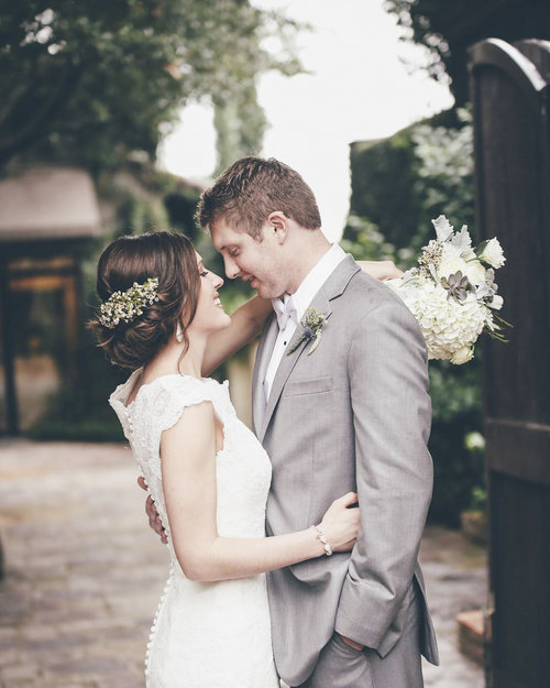 Bride+and+Groom+Embrace+in+WW+Courtyard+in+front+of+gate.jpg